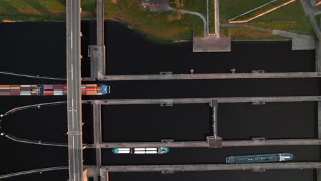 containership crossing under krammerbrug in bruinisse, netherlands. aerial topdown shot