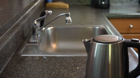 shot of a kitchen sink and kettle