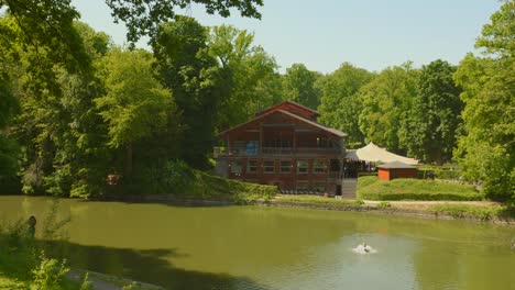 exterior facade of chalet robinson - restaurant by the lakeshore in bois de la cambre in brussels, belgium