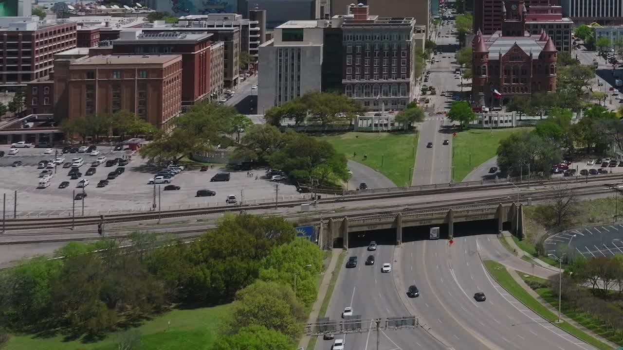 Sky view of downtown Dallas showing roads, buildings, and green spaces