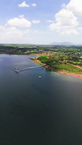 aerial view dolly of the small house by the lake in dong nai.