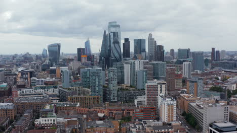 Rising-shot-of-modern-city-borough.-Group-of-business-skyscrapers.-Iconic-Walkie-Talkie,--Gherkin,-Scalpel-and-other-buildings.-London,-UK