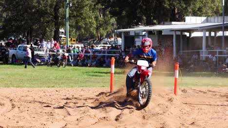 motorcyclist performing in a sandy track event