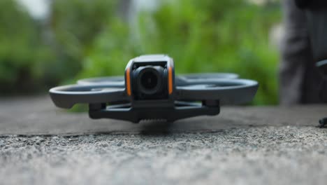 Close-up shot of Dji avata FPV drone taking off from ground and landing