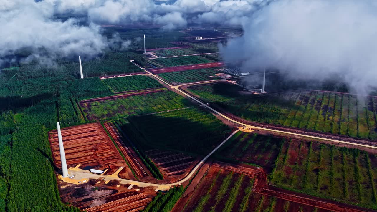 Wind turbine farm under construction on a open rural field, aerial drone view