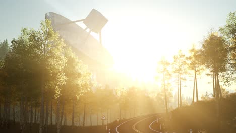 the observatory radio telescope in forest at sunset