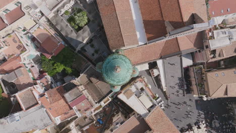 top down aerial footage flying up away from the spire of a church, the duomo di amalfi in amalfi