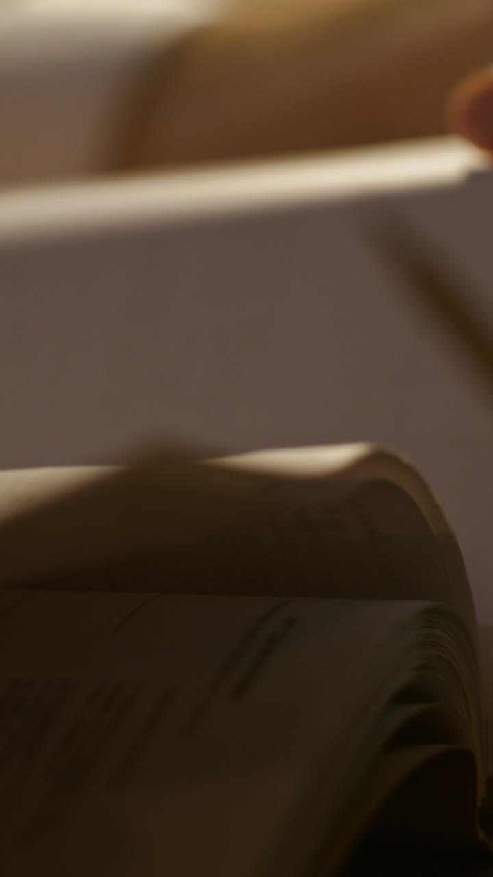 Close-up of a person's hand on a book