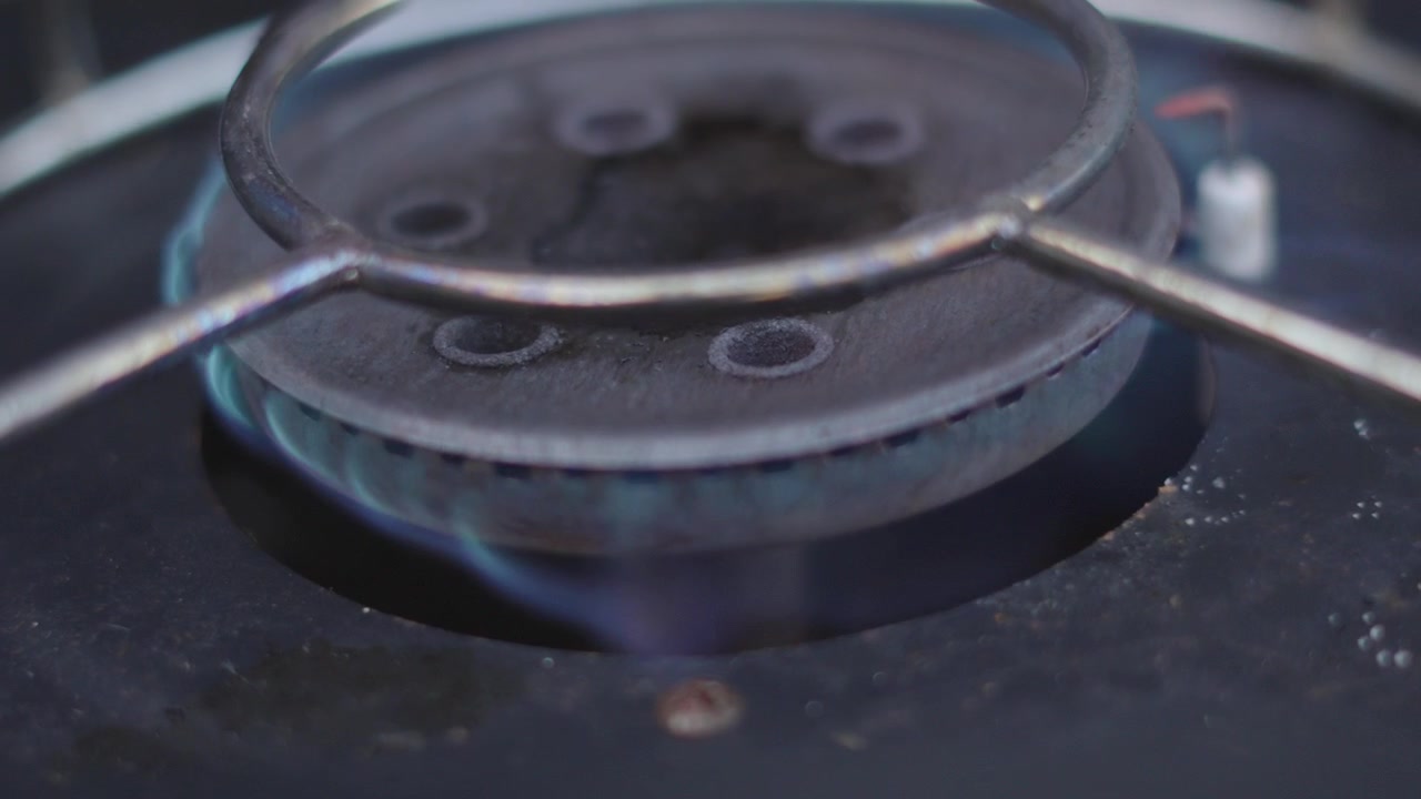 Close-up of Gas Stove Burning with Blue Flames.