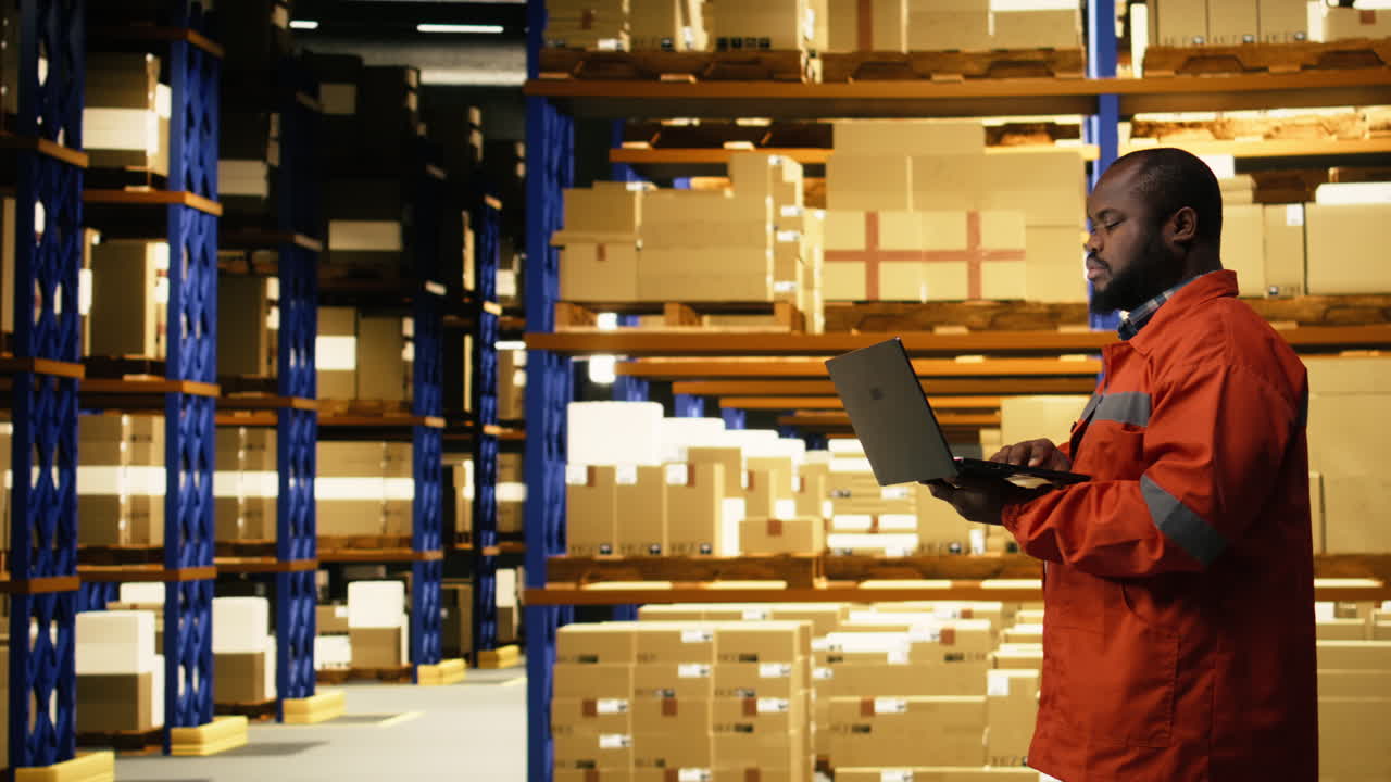 Portrait of african american worker using laptop for inventory management