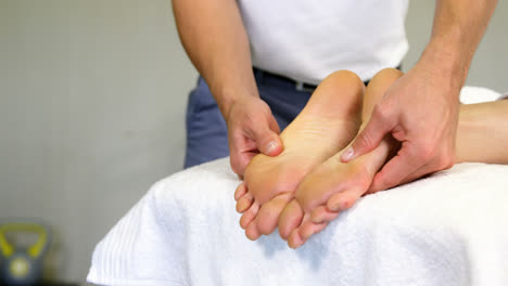 physiotherapist giving foot massage to a woman