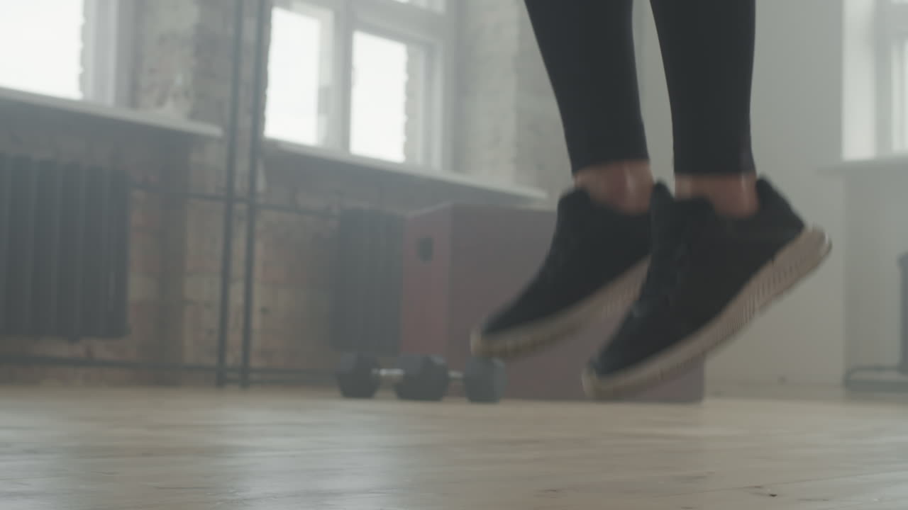 Unrecognizable Legs Jumping Rope Indoors