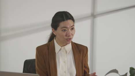 male candidate being interviewed in office for job by female interviewer viewed through window 1