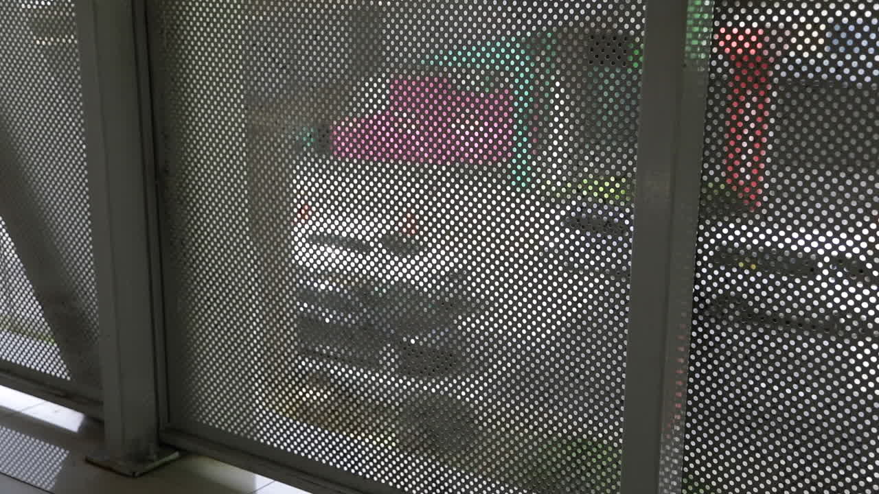 Moderate City Traffic view through the walkway bridge of Public LRT Railway in Kuala Lumpur Streets of Malaysia