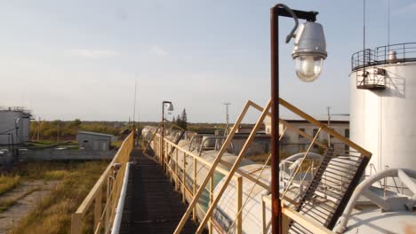 abandoned industrial facility with oil tanks