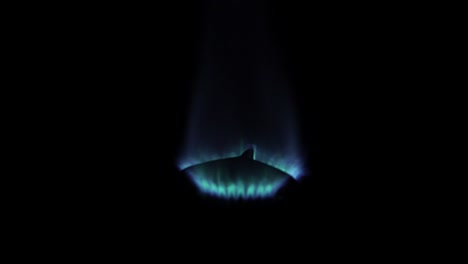 Blue-gas-burner-lighting-up-in-dark,-slo-mo