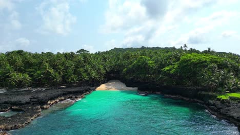 Low-fly-over-the-sea-with-the-Bateria-beach-as-background-at-Ilheu-das-Rolas,Sao-Tome,Africa