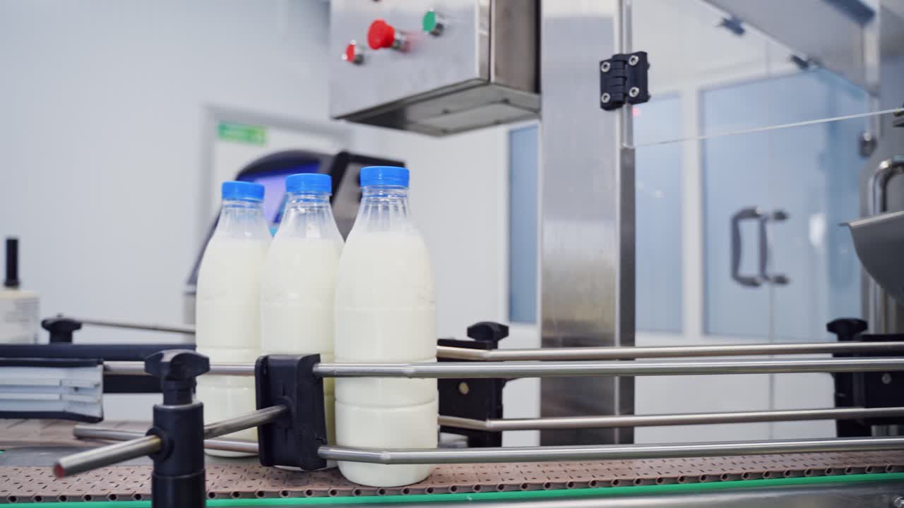 Milk production line. Milk bottles on industrial conveyor