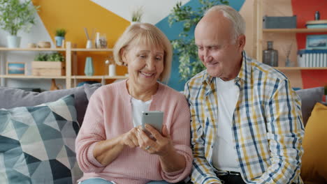 senior couple using smartphone at home