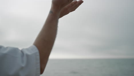 karate man training fight by waving arms close up. strong sportsman training.