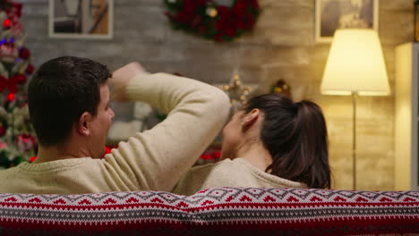 back view of young woman resting her head on boyfriend shoulder