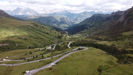 pordoi mountain pass at trentino, south tyrol, dolomites, italy - aerial drone view of the hairpin bends and green valley in the italian alps