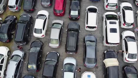 AERIAL:-Drone-Takes-off-Above-the-Packed-Parking-Zone-with-Cars-which-Wait-in-Queue-to-be-Transported-by-Ferry-from-The-Koh-Chang-Island-to-Mainland-of-Trat,-Thailand,-Asia