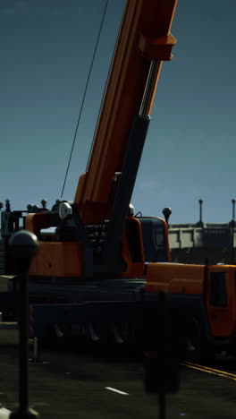 large orange crane on a road