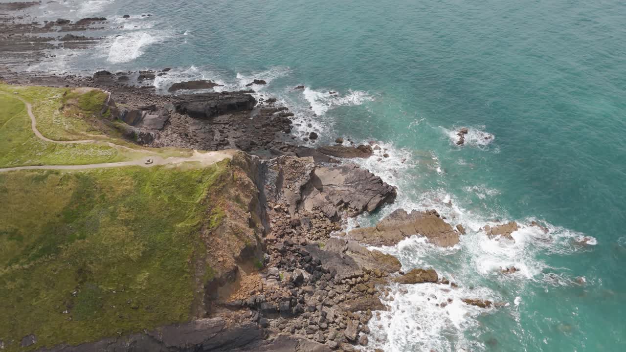 Aerial View of Dramatic Rocky Coastline and Ocean Waves