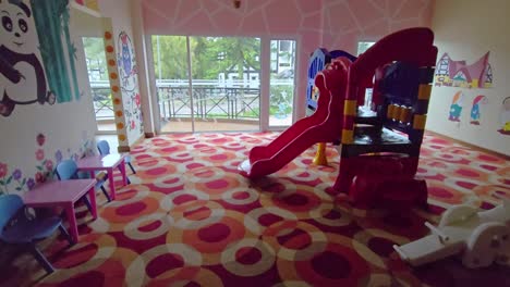 kindergarten and children's playroom with slide and climbing frame. kids gameroom for fun and enjoyment indoors.