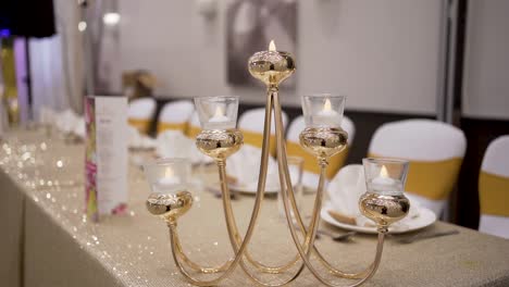 stunning wedding candle decoration piece on a dining table at the wedding venue