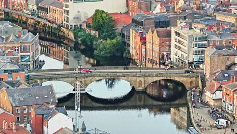 drone tilt down shot of bridge in york city centre, cathedral city in north yorkshire, england