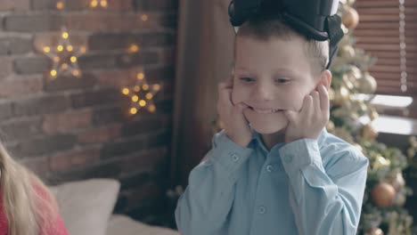 boy in blue shirt with vr headset fools around makes faces