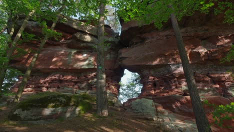 Unique-red-rock-towers-in-the-middle-of-a-shaded-forest,-Altschlossfelsen,-Germany