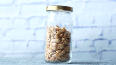 Peanut-in-a-glass-jar-on-table-,