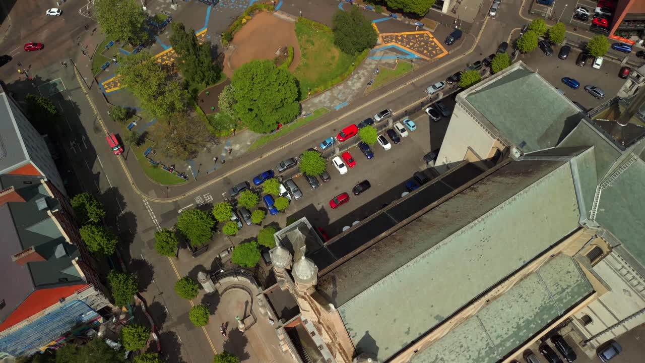 Ultra-wide, advancing aerial video of St Anne's Cathedral in the Cathedral Quarter in Belfat City Centre, Northern Ireland on a bright and sunny day. Filmed in 4K, 60FPS and with Rec709 Color.