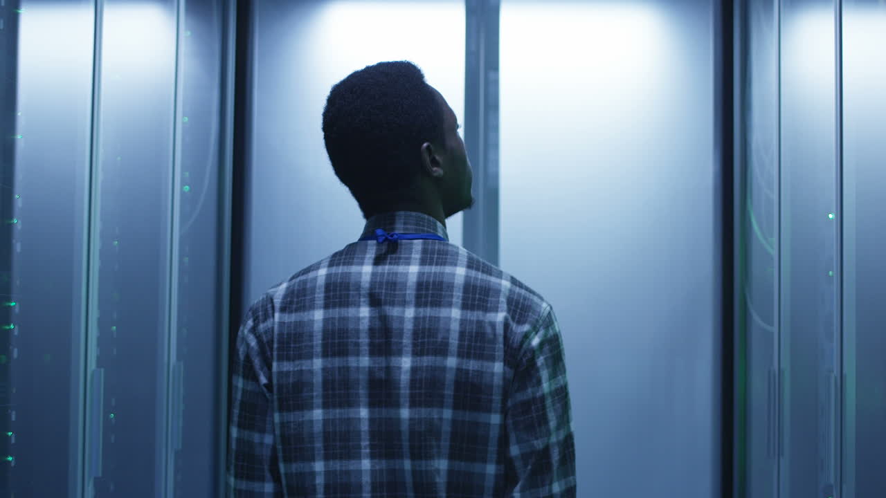 IT professional inspecting equipment in a modern data center