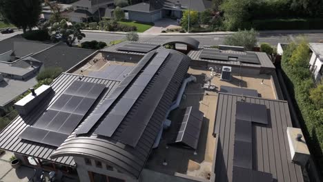a solar panel project on a modern building in encino hills, california, on a sunny day, aerial view