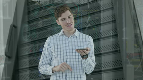 animation of binary coding and caucasian businessman using smartphone over server