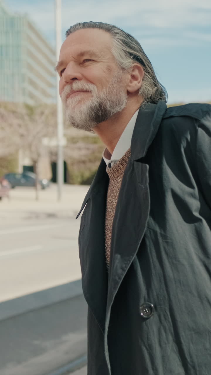 Smiling Senior Man Waits at Transit Stop