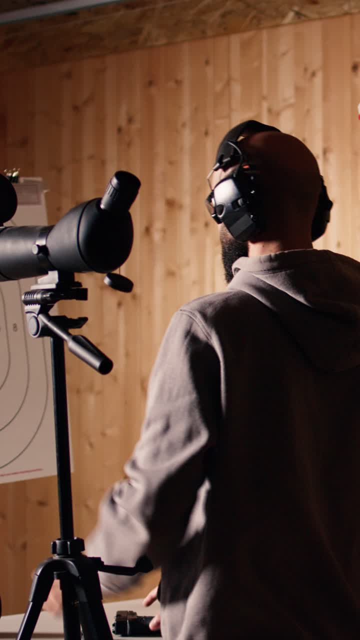 Vertical video Friends in firing range shooting, zooming to check points scored on bullseyes