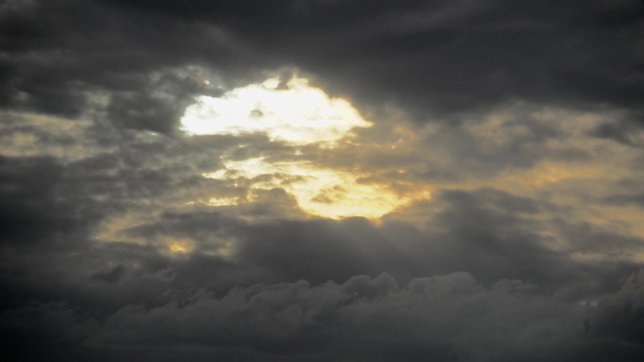 Sunlight Breaking Through Dark Storm Clouds