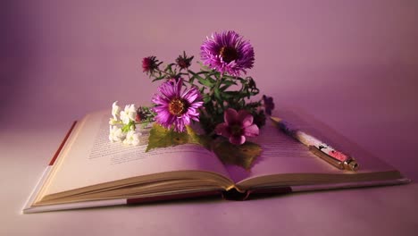 Close-Up-of-Flowers-and-Pen-on-the-Book