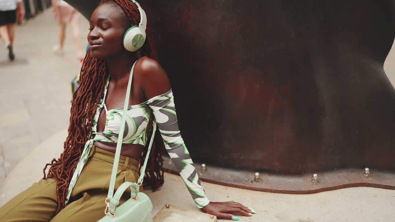 Stylish woman with headphones in an urban setting
