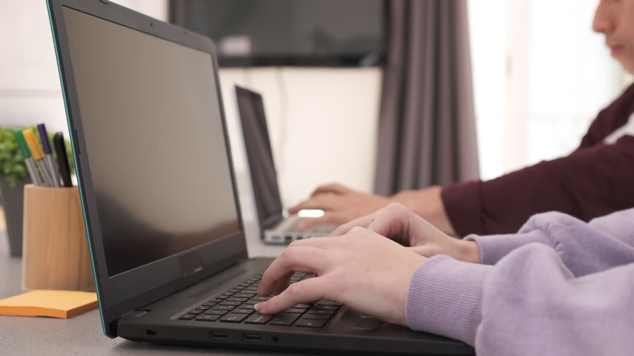 Focused Young freelancer couple sitting at desk working at home. Freelance, home office, remote work, online concept