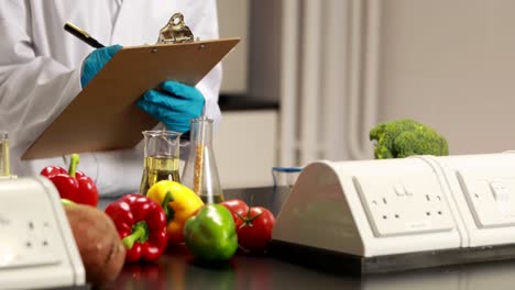 Scientist-taking-notes-on-food-experiment