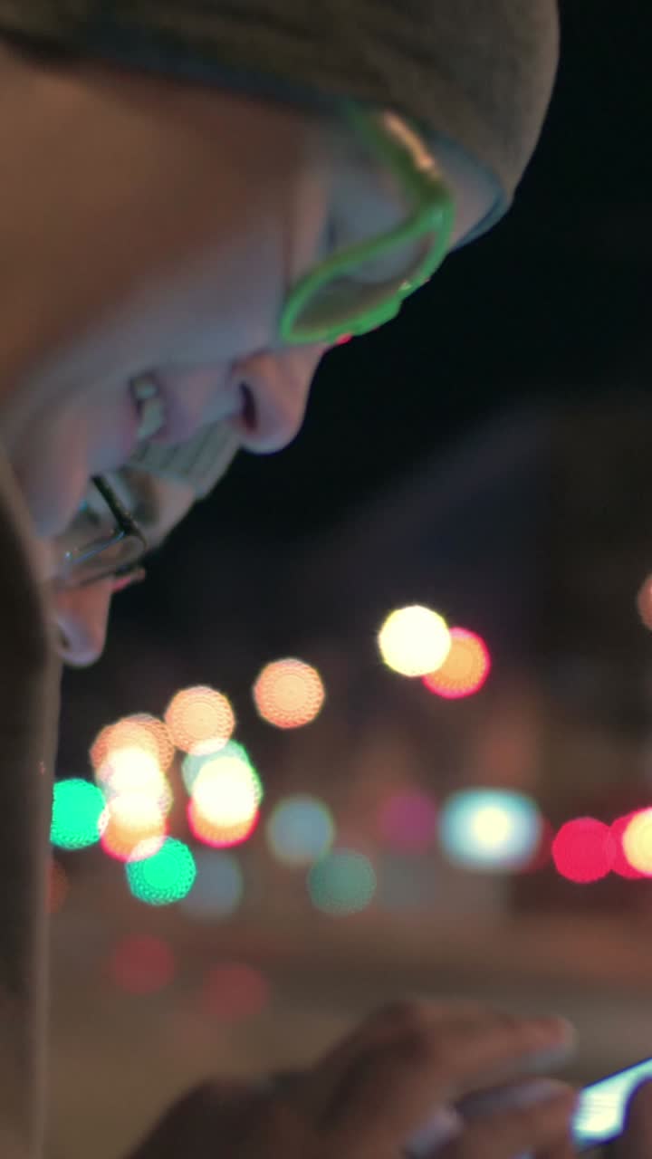 People using technology at night