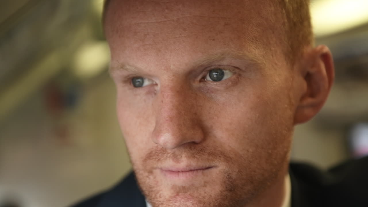 Close up of bored Businessman face in London Underground during commute to work, light flashing, going into tunnel