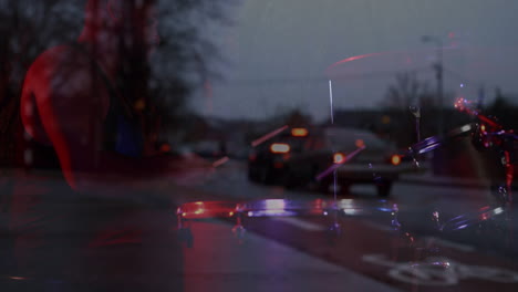 animation of blurred road traffic over biracial male musician playing percussion