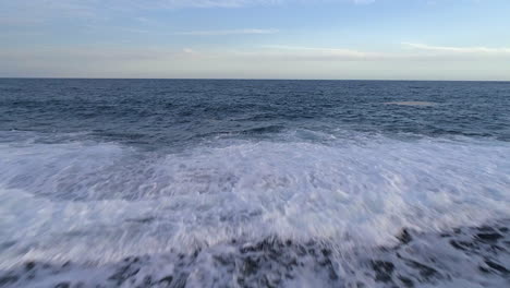 aerial drone view over waves, towards the endless sea at the playa los cuadritos beach, in dominican republic